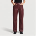 wine red leather pants on an off-gray studio background