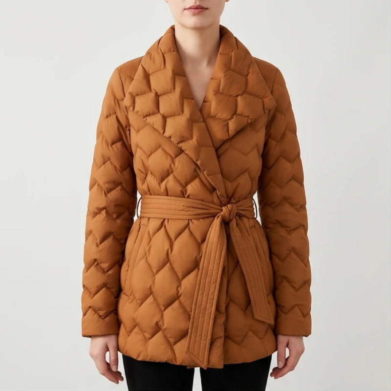 Woman wearing a waist-length, warm brown quilted puffer coat with a wide collar and a self-tie belt knotted at the waist.