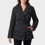 Woman wearing a black quilted puffer coat with a wide lapel collar and a belted waist, standing against a white background.