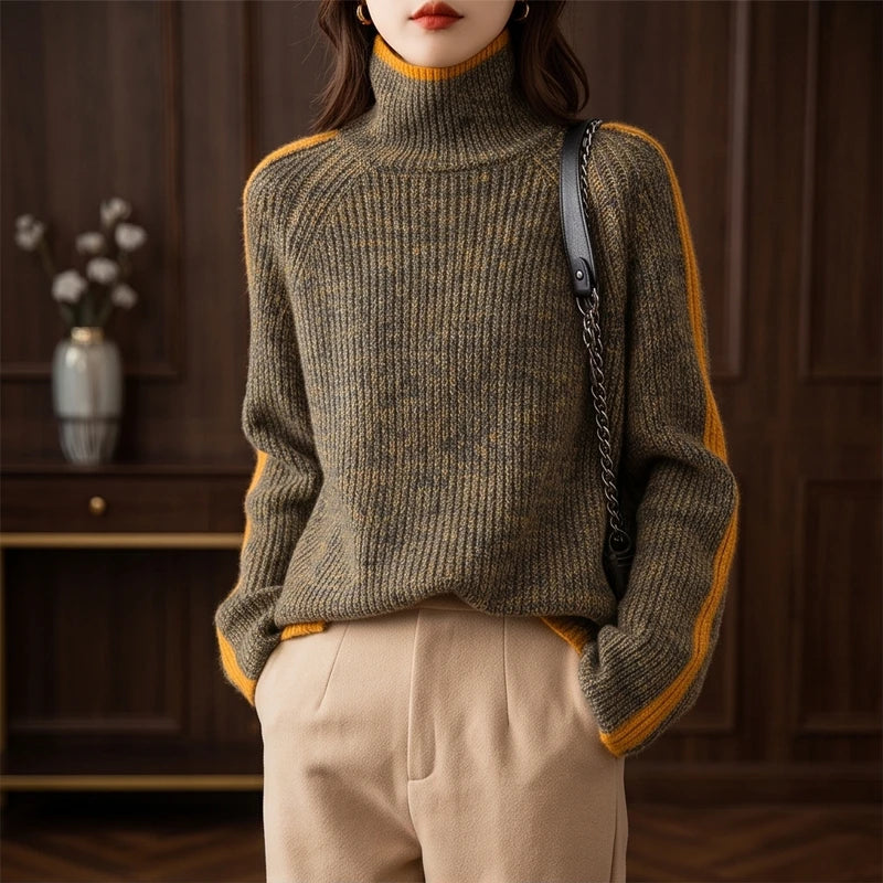 Woman wearing a green and yellow mottled knit sweater with a contrasting yellow roll neck and arm stripes.