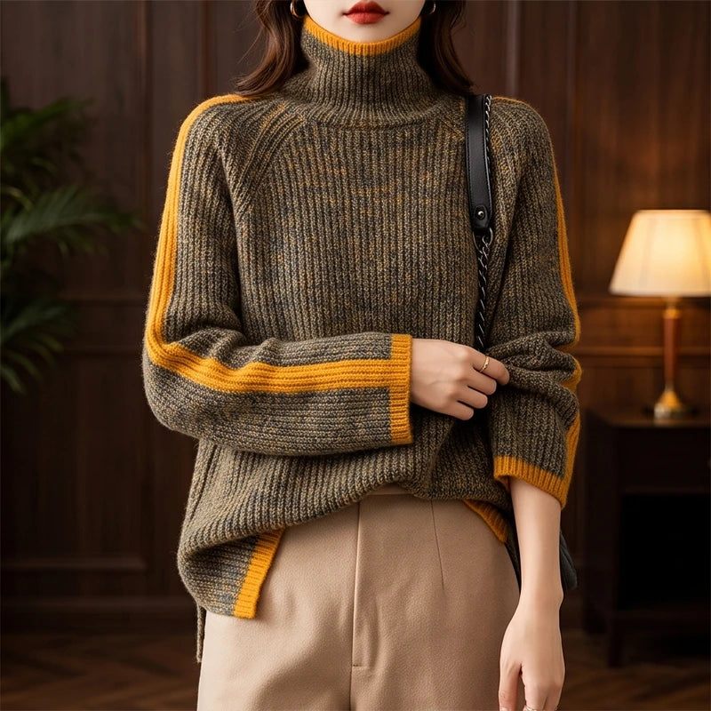 Woman wearing a dark green marl roll neck knit jumper with wide orange stripes on the sleeves and hem over light brown pants.