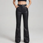 Black leather pants on an off-gray studio background