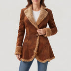 Woman wearing a brown suede coat with a wide faux fur collar, cuffs, and trim, over a white t-shirt.